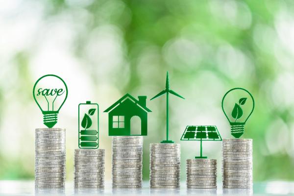Green eco-friendly symbols atop coin stacks