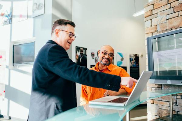 Two business colleagues looking at a laptop collaborating