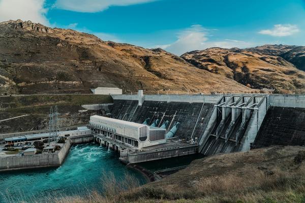 A large hydroelectric power plant and dam in a mountain landscape