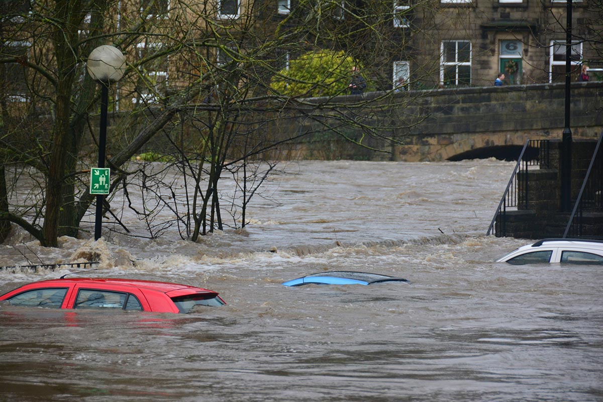 Cars submerged under floodwater in an urban environment