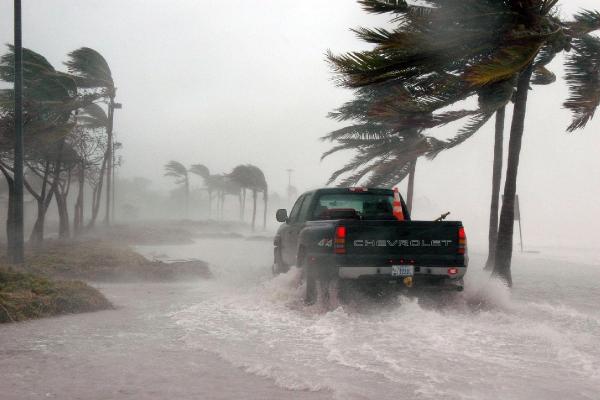 A pick-up truck driving through floodwater during a storm in Florida