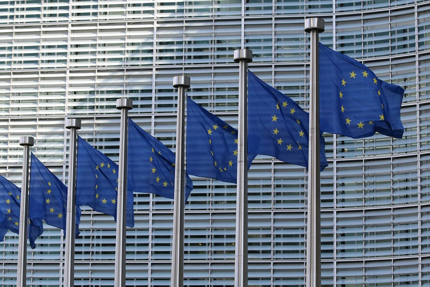 Line of EU flags in front of European Commission Building