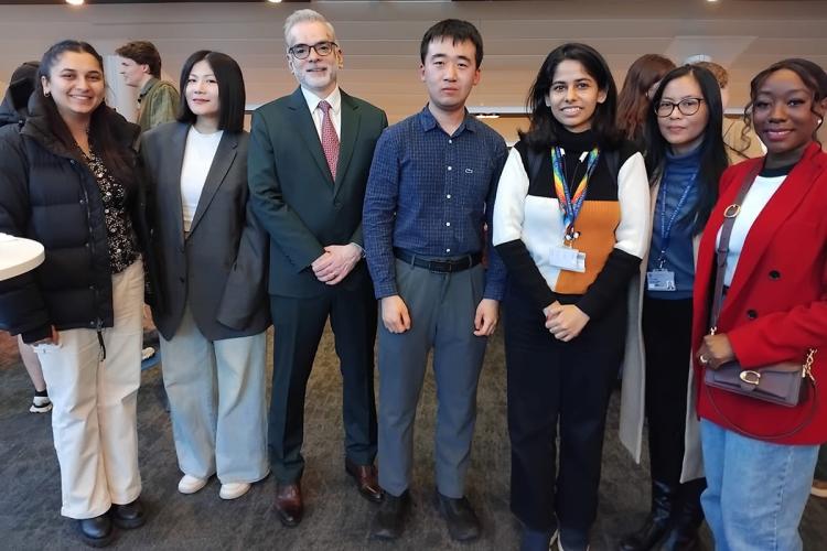 Dr Pradeep Tharakan in a group shot with a group of six business school students